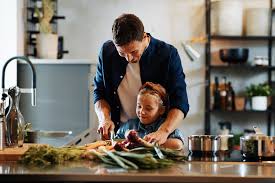 Dad cooking for daughter
