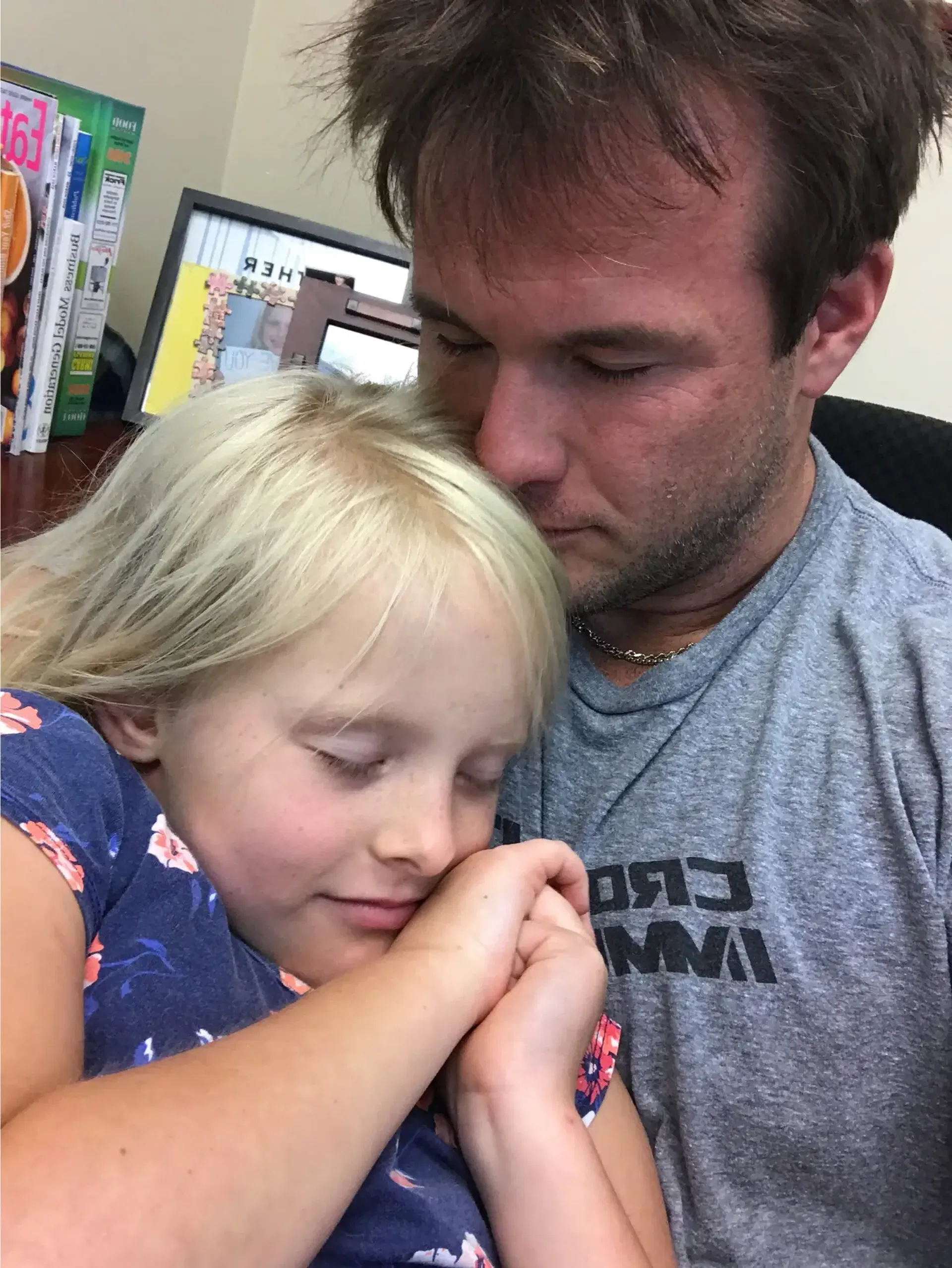 Robert W. Kuypers holding his daughter during a quiet family moment