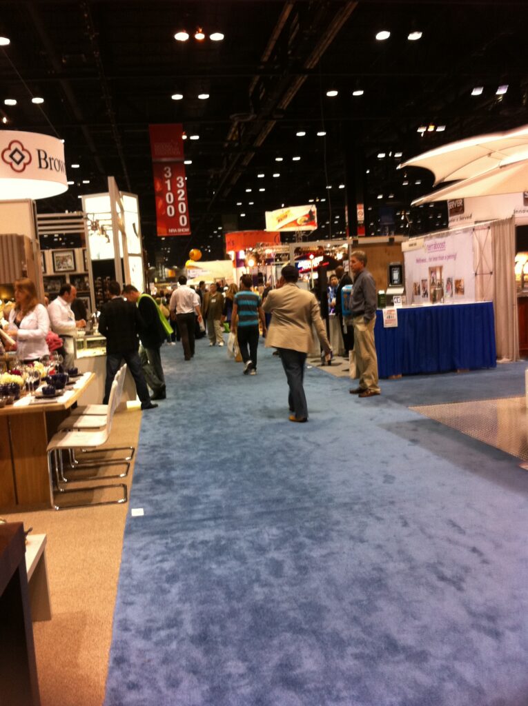 Visitors exploring a large trade show.