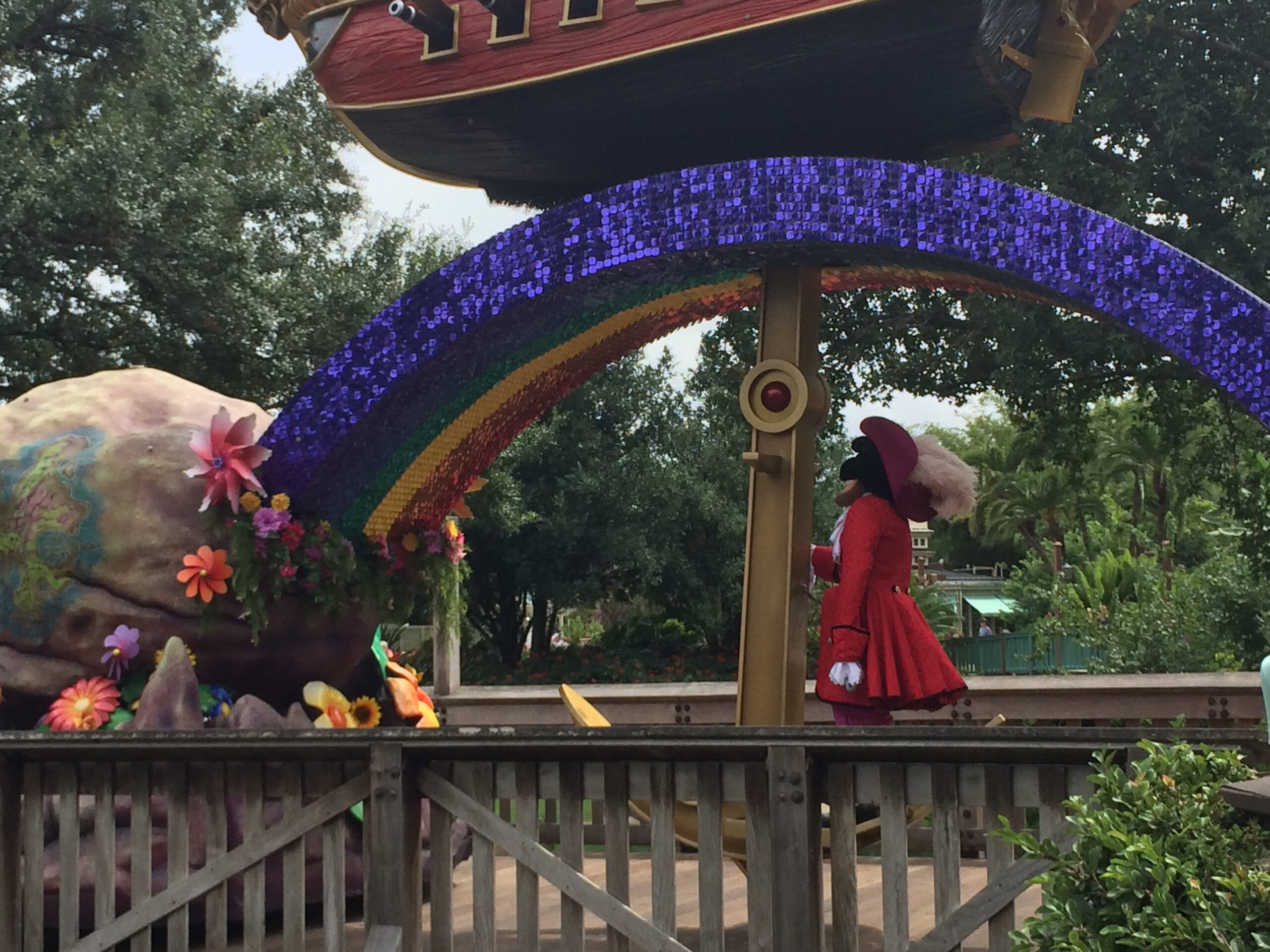 Colorful outdoor stage performance in a garden setting.
