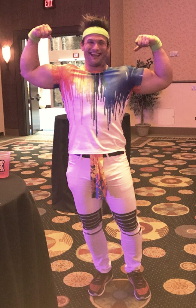 Adult posing in a colorful party costume.
