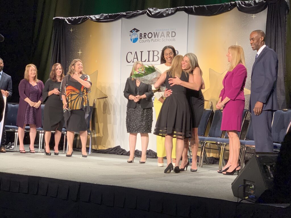 Guests gathered on stage at an awards event.