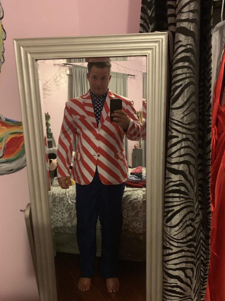 Man wearing a stars-and-stripes shirt for a mirror portrait.