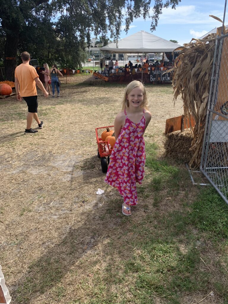 Child exploring an outdoor autumn festival.