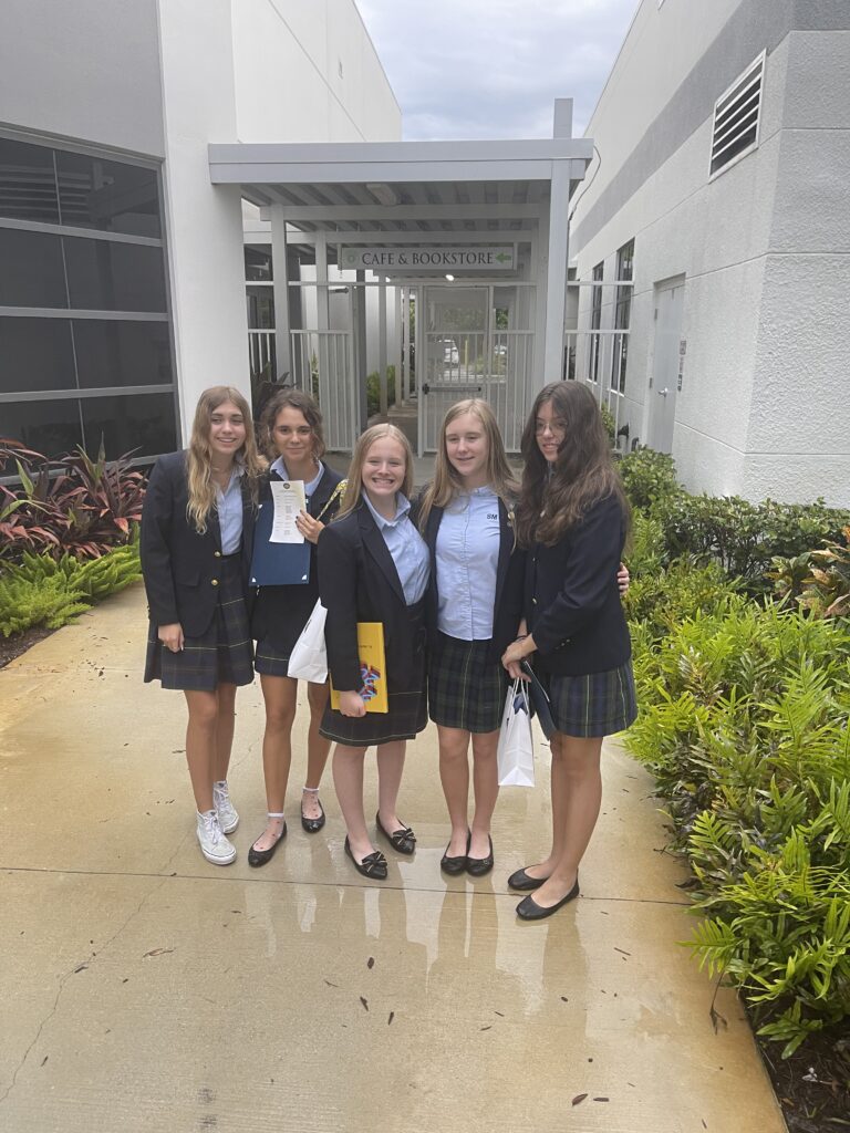 Group of young people posing together outdoors.