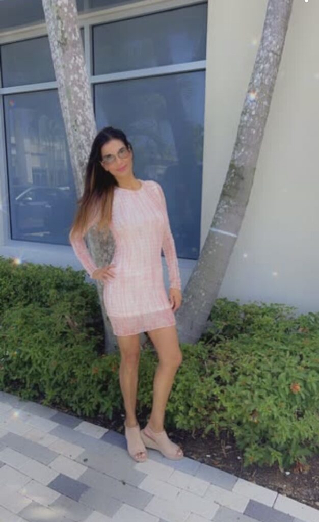 Woman dressed for an outing standing outdoors.
