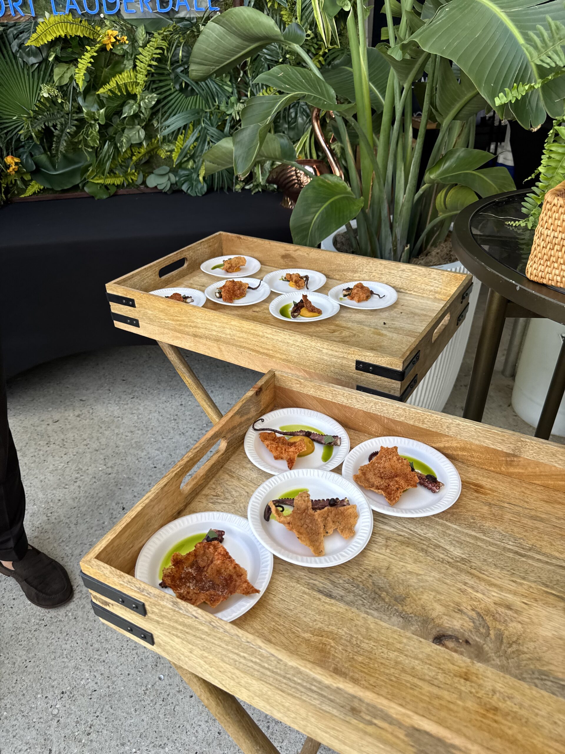 Small tasting plates arranged on wooden trays.