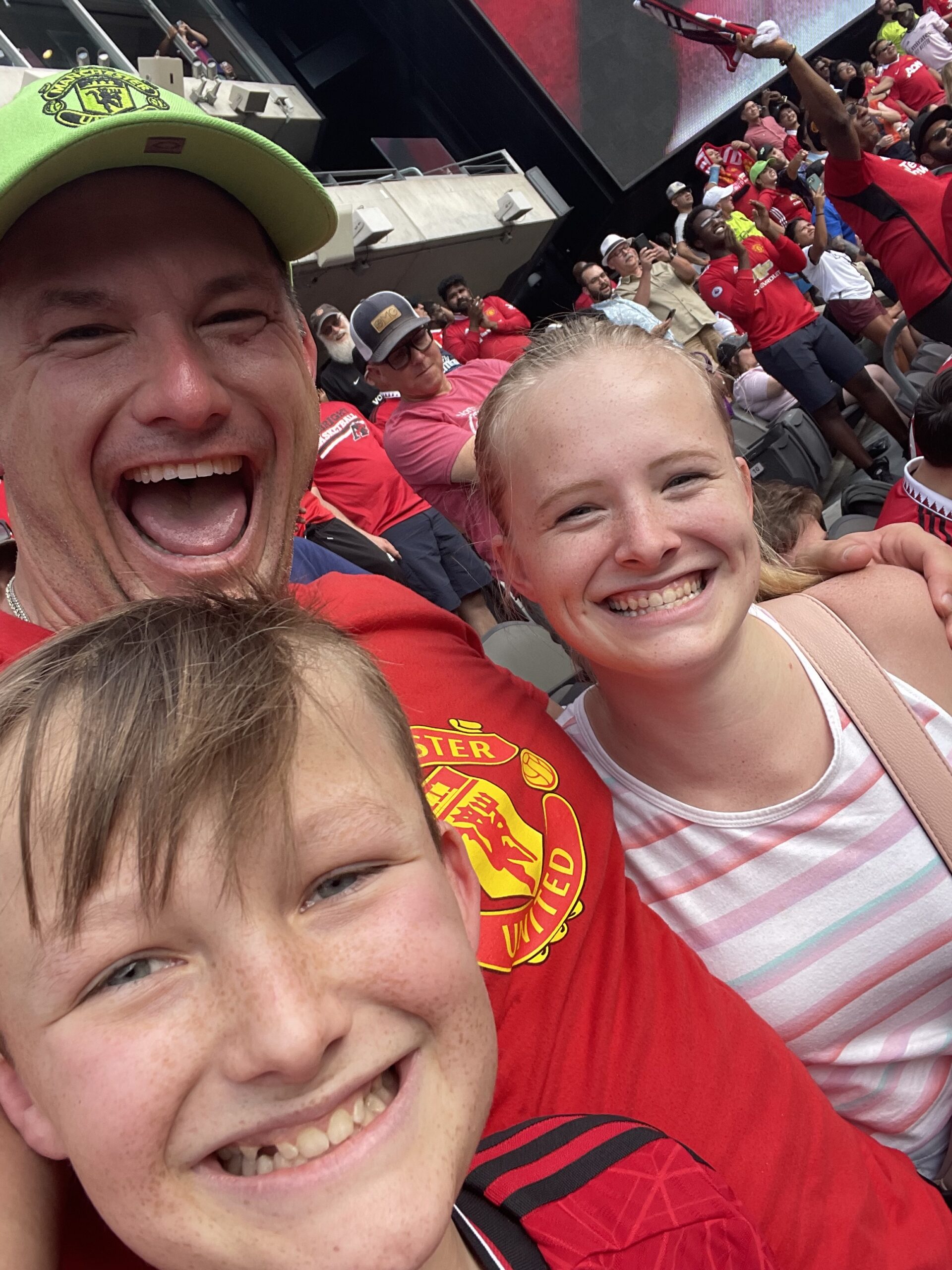 Robert W. Kuypers with Kenley and Braden cheering at Manchester United.