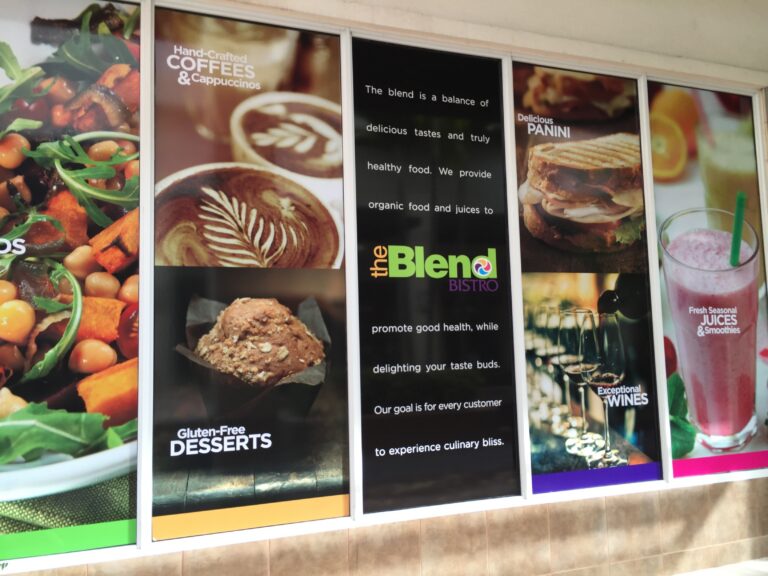 The Blend Bistro window display advertising coffee, panini, desserts, wine, and smoothies.
